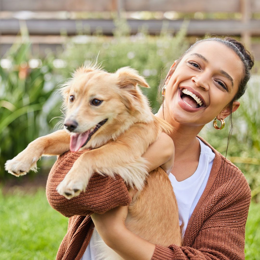 Smiling Woman Holding Dog