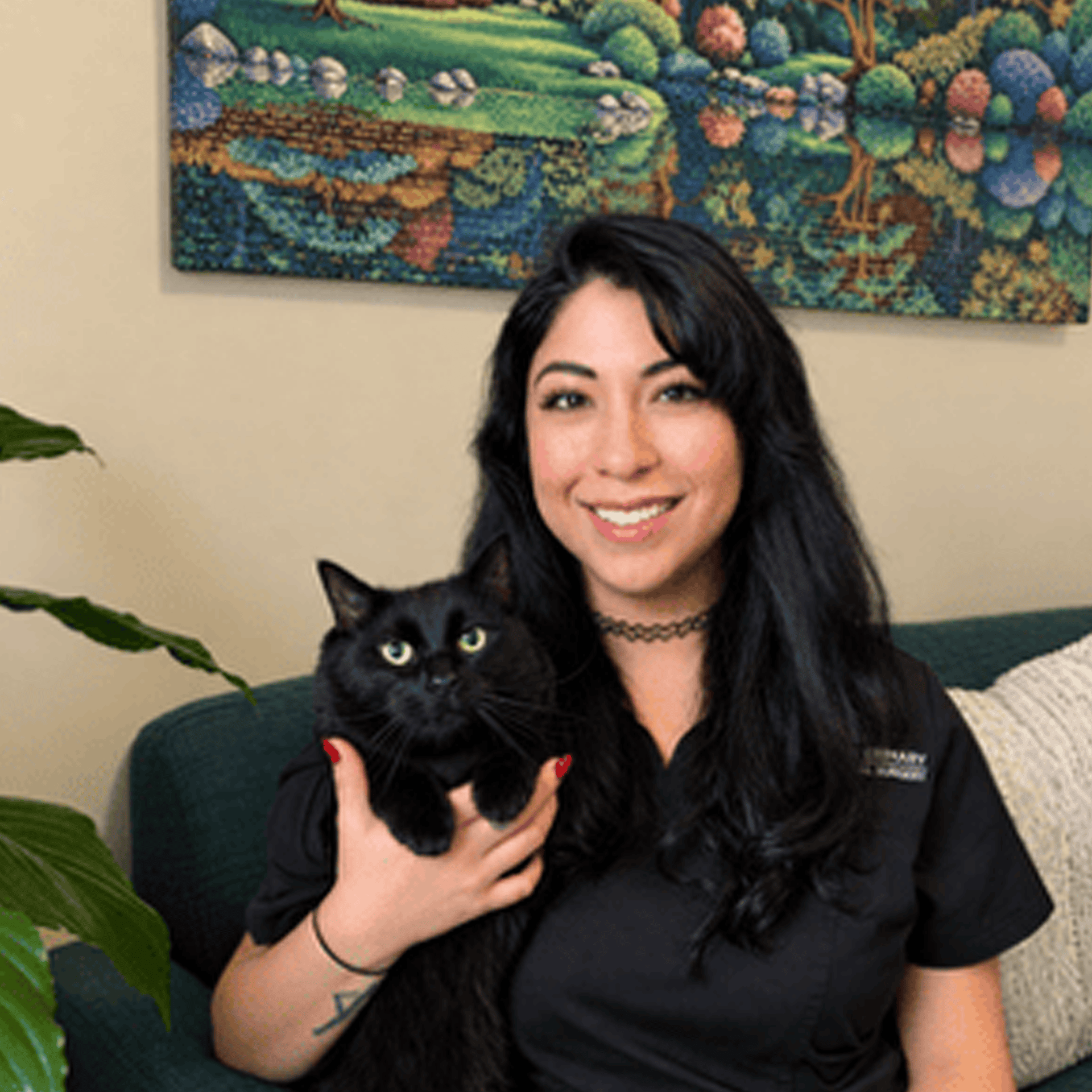 Jenny smiling with a black cat