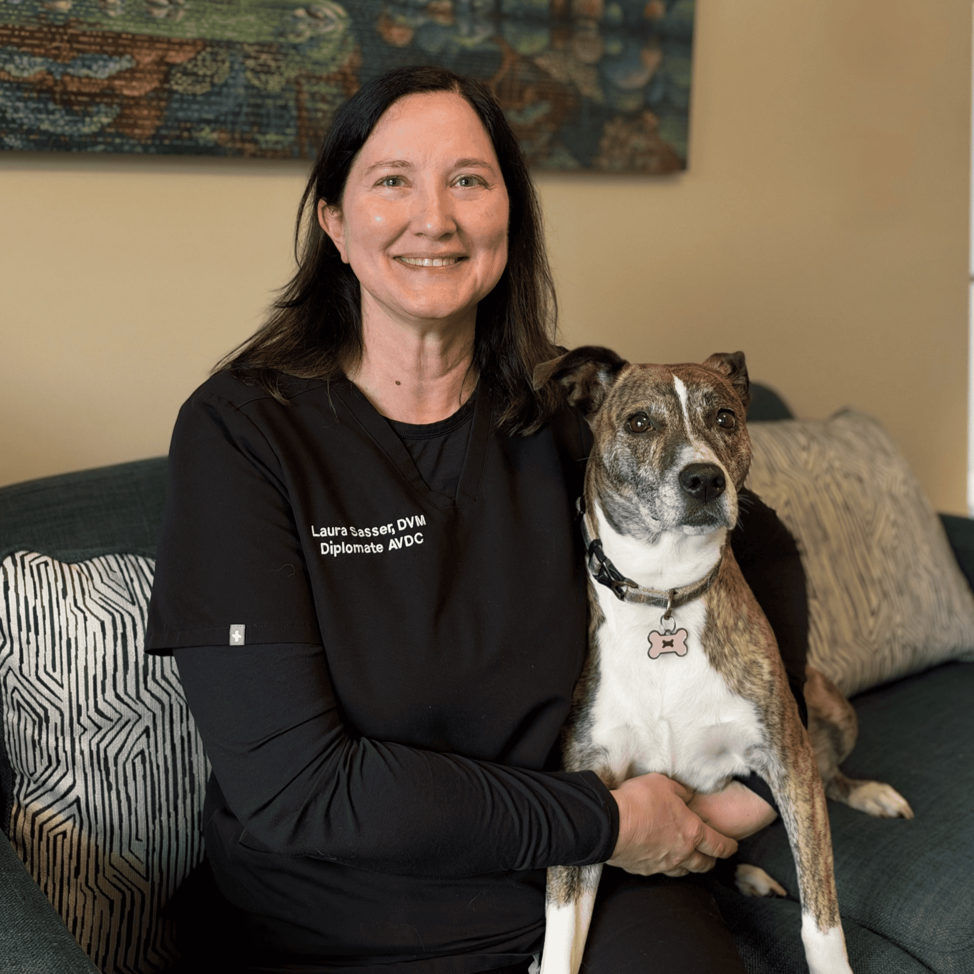Dr. Sasser smiling with a dog